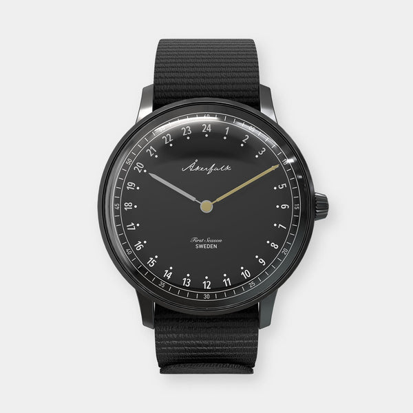 24-hour watch with matte black case and black NATO strap