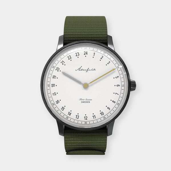 24-hour watch with matte black case and green NATO strap
