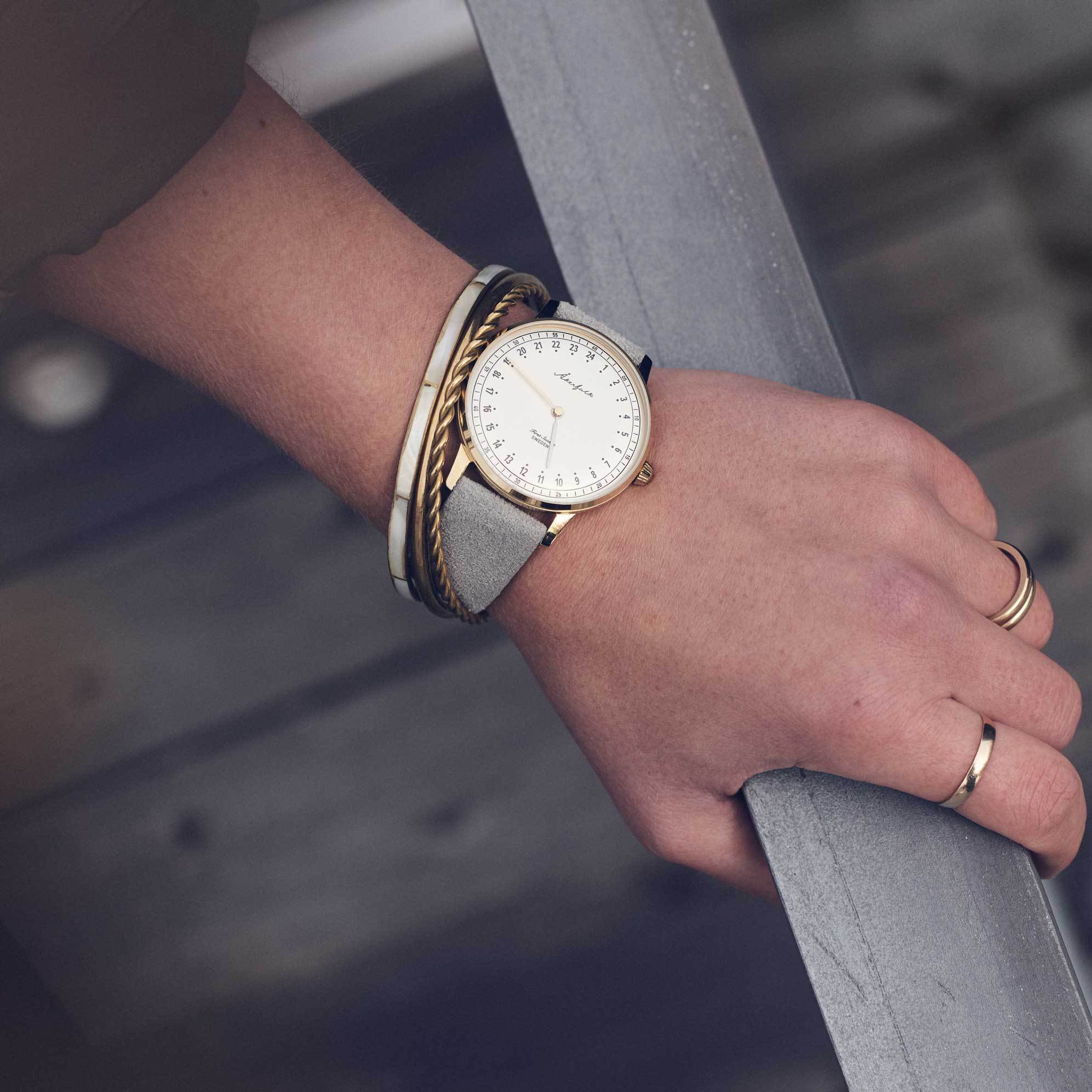 24-hour watch with gold case and grey mocha strap